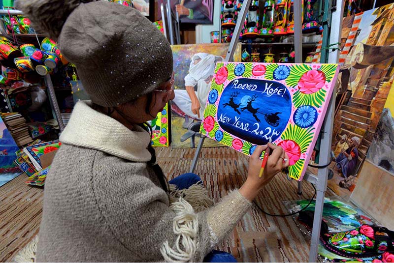 An artist painting on canvas in the connection of upcoming New Year