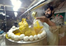 A vendor selling chicken soup (Yakhni) at his roadside setup during winter season.