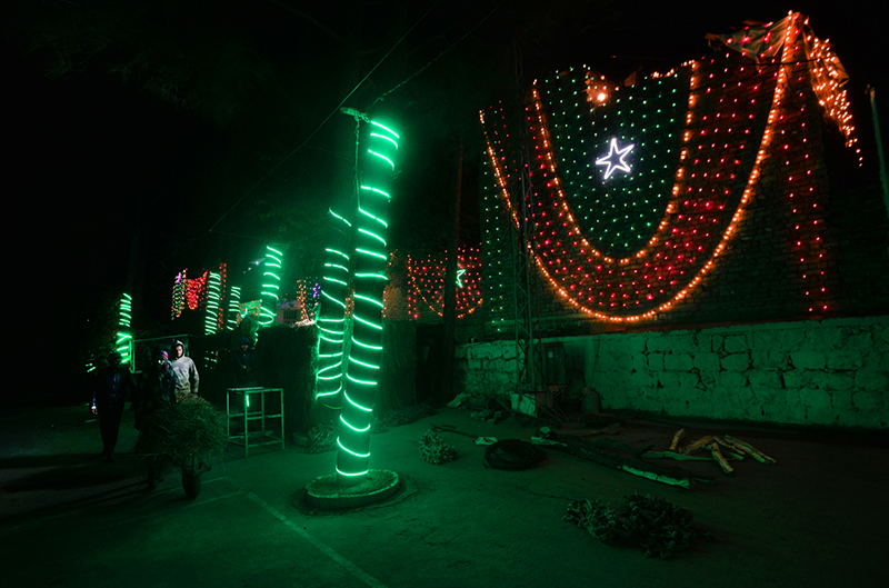 A man decorating lights ahead of Christmas celebrations at 100 quarters