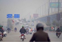 Fog covers the horizon of city creating problems for commuters at Murree Road