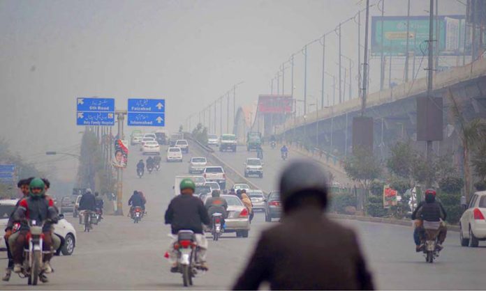 Fog covers the horizon of city creating problems for commuters at Murree Road