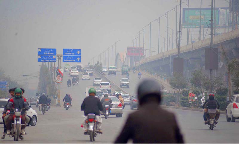 Fog covers the horizon of city creating problems for commuters at Murree Road