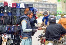 Customers selecting and purchasing warm gloves during the winter season