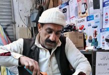 A worker repairing gas heater at his shop