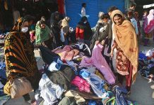 People busy in selecting and purchasing second hand warm clothes at Liaquat Market