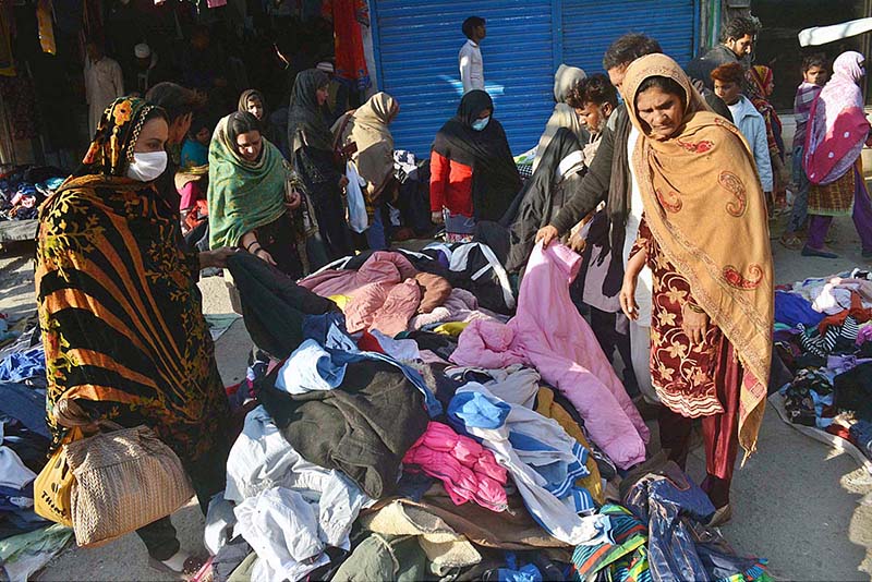 People busy in selecting and purchasing second hand warm clothes at Liaquat Market