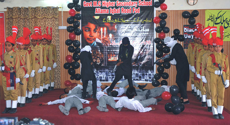 Students are performing tableau to tribute martyrs of APS Peshawar at Govt M.C Higher Secondary School Allama Iqbal Road