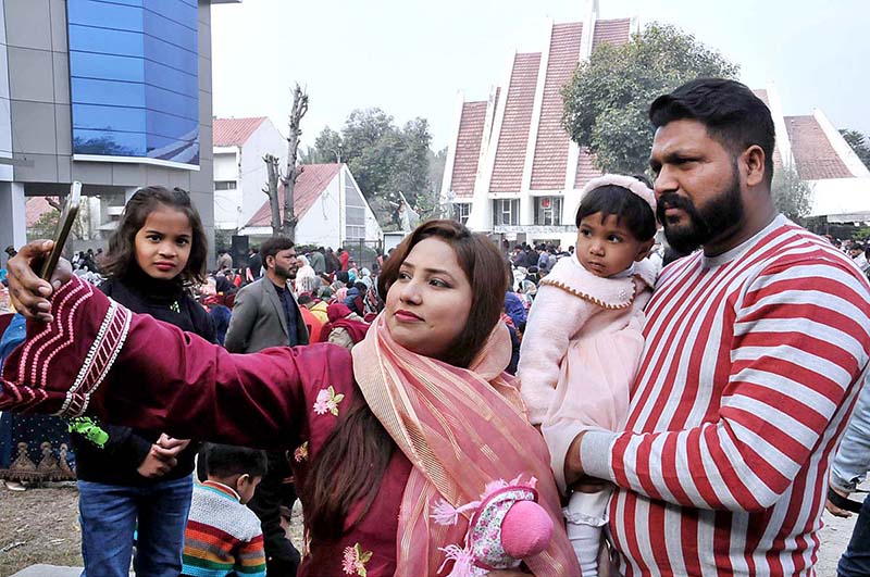 A Christian family taking selfie after performing religious rituals on Christmas day at Fatima Church F-8