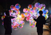 Vendors displaying the lighting balloons to attract the customers at Latifabad