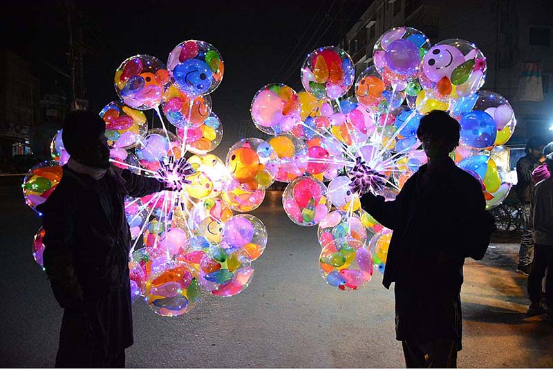 Vendors displaying the lighting balloons to attract the customers at Latifabad