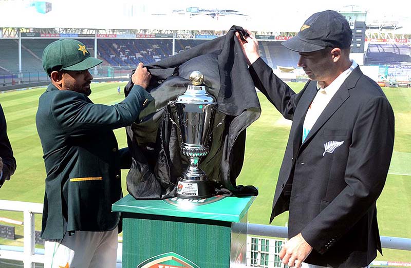 Pakistan Cricket Team captain Babar Azam and New Zealand's captain Tim Southee posing for photograph after unveiling Test Series Trophy ahead of first Cricket Test match at the National Stadium.