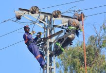 HESCO staffers repairing electric wires on the pole at Tando Hyder Road