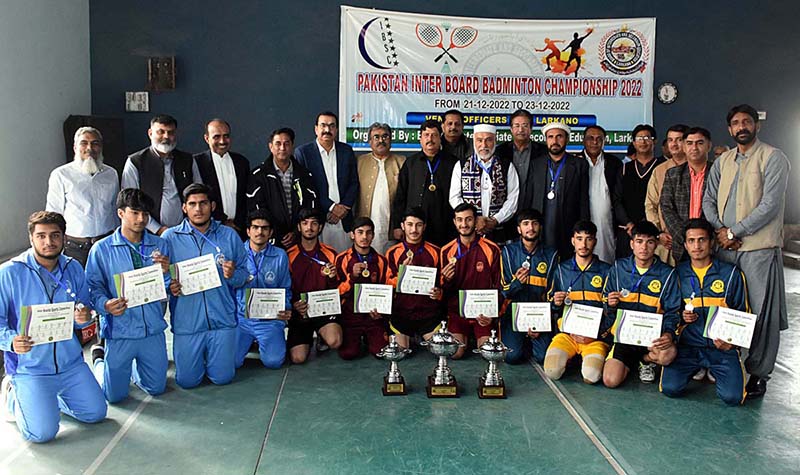 A group photo of chief guests Regional Director Colleges Professor Ahmed Bux Bhutto with the Players of First position Peshawar, second Malakand and the third position holder of Sahiwal Education Boards teams in the All Pakistan Inter Board Badminton Championship 2022 during closing ceremony at Officers Club, organized by Board of Intermediate and Secondary Education Larkana