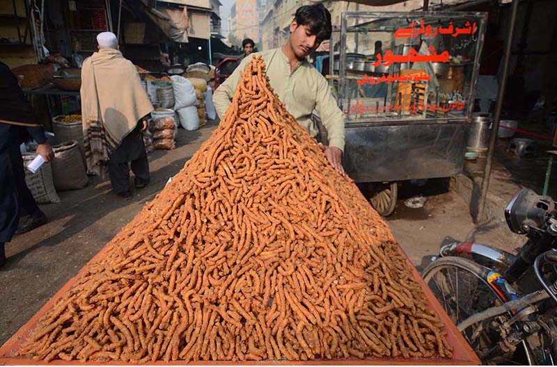 Vendor selling and displaying traditional sweet item to attract the customers at Firdous area