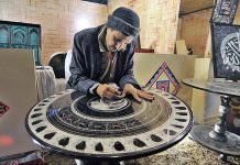 An artisan demonstrating his skills at a stall during Folk Festival ‘Lok Mela’ 2022 at Lok Virsa