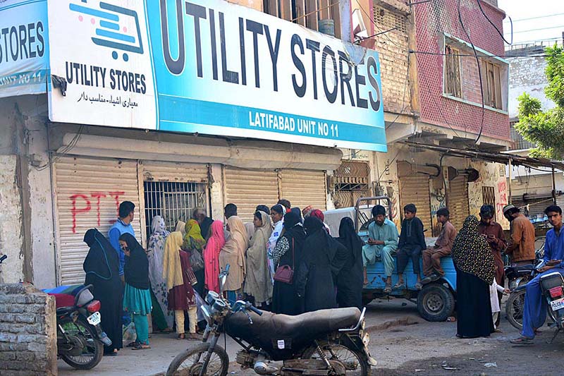 A large number of people standing in queue outside Utility Store to purchase grocery items on subsidized rates at Latifabad