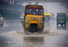 Vehicles passing through stagnant rain water accumulated at GT road during rain in the Provincial Capital