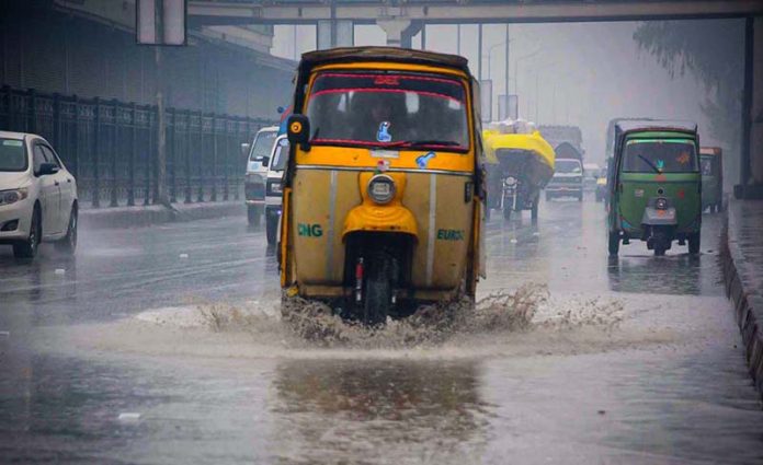 Vehicles passing through stagnant rain water accumulated at GT road during rain in the Provincial Capital