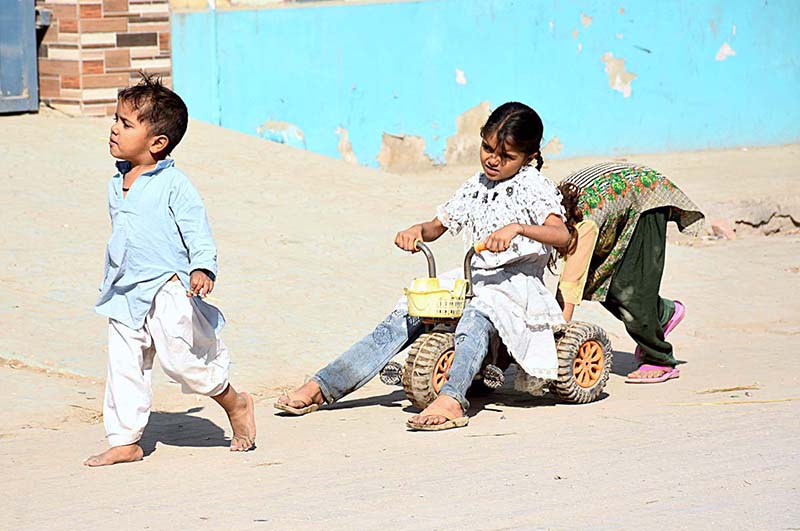 Children playing outside their house at Old Bus Stand Road