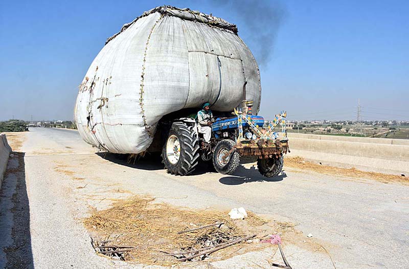 An overloaded tractor trolley with chaff (husk from wheat) on the way at damaged Bypass Bridge near Otha Chowk which may cause any mishap and needs the attention of concerned authorities.