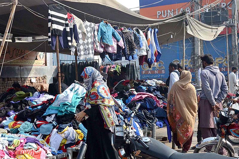 People selecting and purchasing second hand clothes from a Landa Bazar