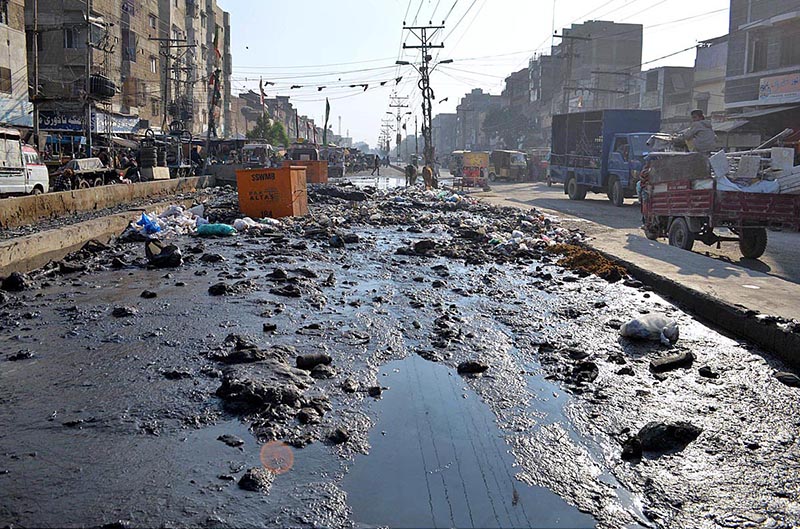 A view of sewerage water accumulated and garbage at Latifabad Road, which required the attention of concerned authorities