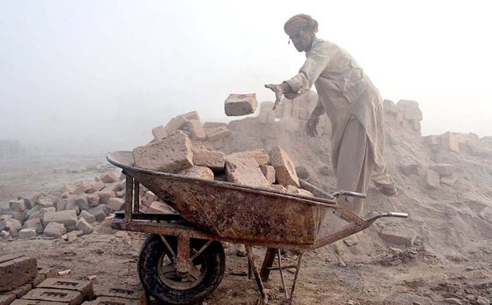 A labourer busy in his work as thick fog engulfs the city at morning time