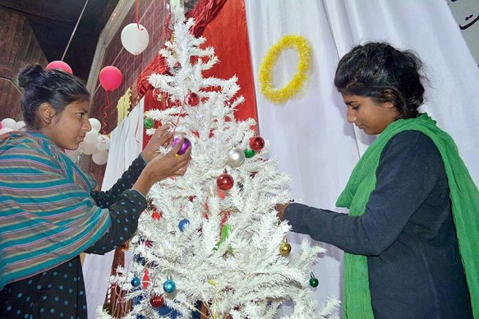 People from Christian community are decorating the UP Church at Nori Gate for upcoming Christmas