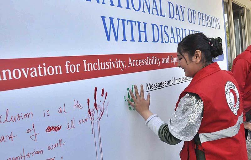 Participants are imprinting their hand marks during the "International Day of Persons with Disabilities 2022" at PRCS HQ