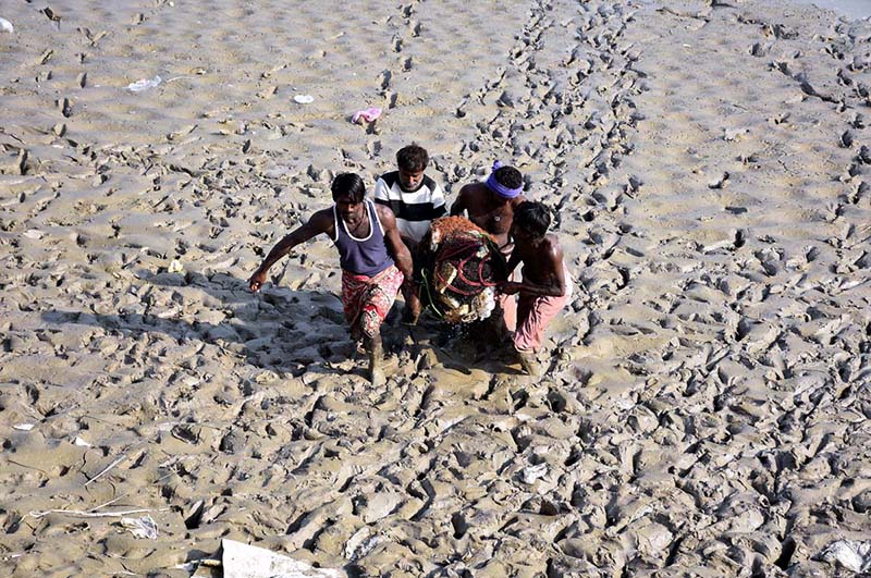 Fishermen hauling out nets after catching fish from the Rice Canal.