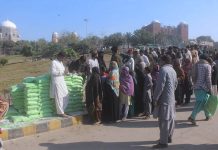 A large number of people standing in queue for purchasing flour on subsidize rates by provincial government.
