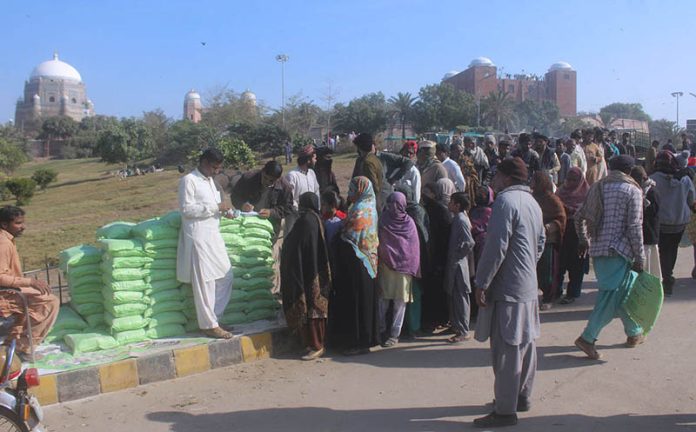 A large number of people standing in queue for purchasing flour on subsidize rates by provincial government.