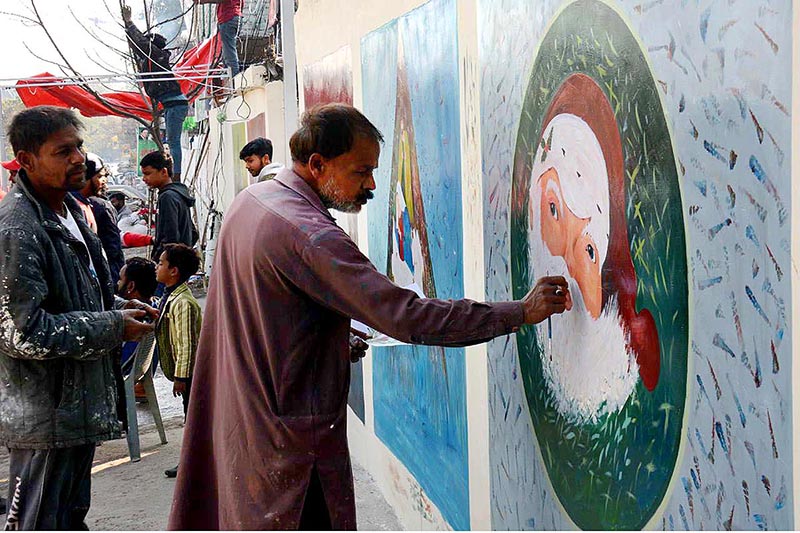 An artist painting on the church wall for decoration in relation with upcoming Christmas and New Year’s celebrations at G-7