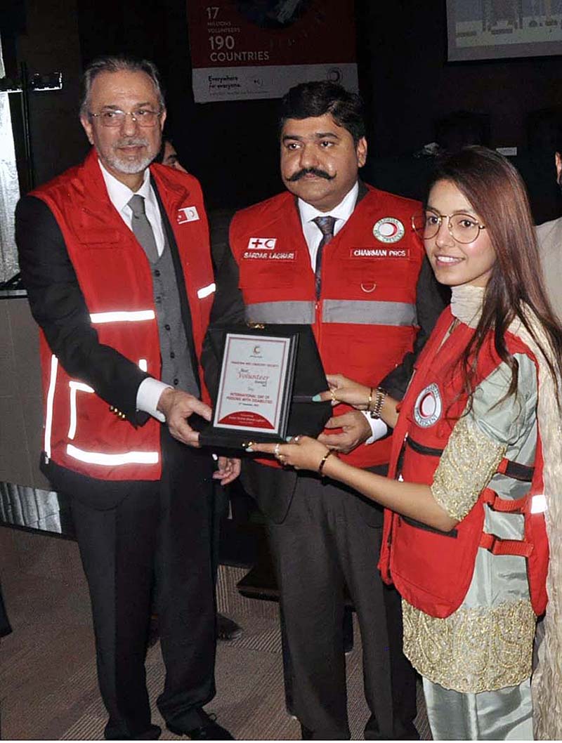 Chairman Pakistan Red Crescent Society Sardar Shahid Ahmed Laghari and Ambassador of Turkiya, Mehmet Pacaci giving away shield to a participant during the "International Day of Persons with Disabilities 2022" at PRCS HQ
