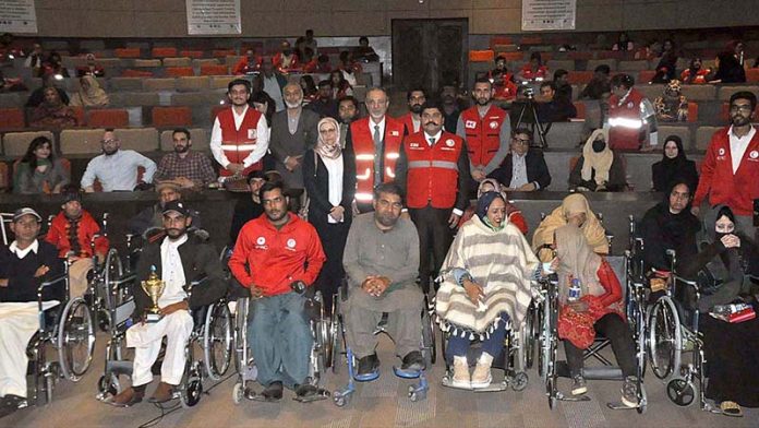 Chairman Pakistan Red Crescent Society Sardar Shahid Ahmed Laghari and Ambassador of Turkiya, Mehmet Pacaci distributing wheel chairs to the special persons during the 