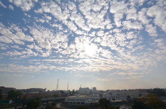 An attractive and eye catching view of sunset as sun rays peeping through clouds hovering over the city.