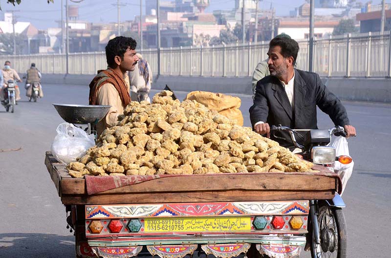 A vendor selling traditional sweet item (Gurr)