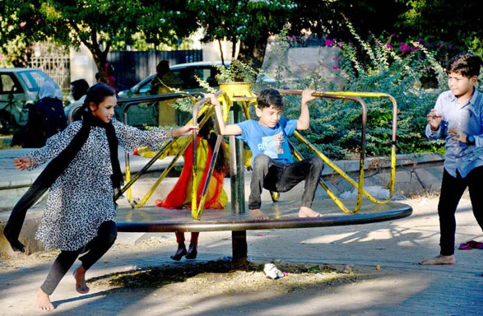 Kids having fun on swing at local Park