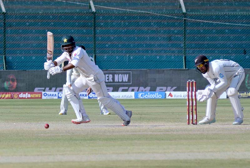 Pakistan's Sarfraz Ahmed gestures with Imam-UL-Haq after scoring a half-century (50 runs) during the fifth and final day of the first Test Cricket Match between Pakistan and New Zealand at the National Stadium