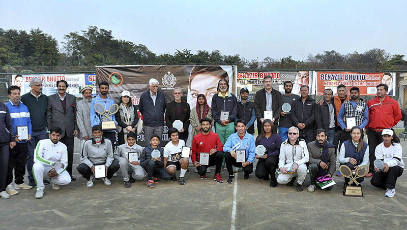 A group photograph with Chief Guest Senator Taj Haider Chairman organizing committee with players of 8th Benazir Bhutto Shaheed National Tennis Championship during closing ceremony held at Islamabad Tennis Complex