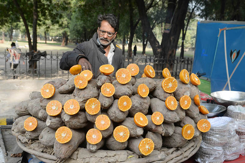 A vendor displaying roasted sweet potatoes (Shakarkandi) to attract the customers at Roadside