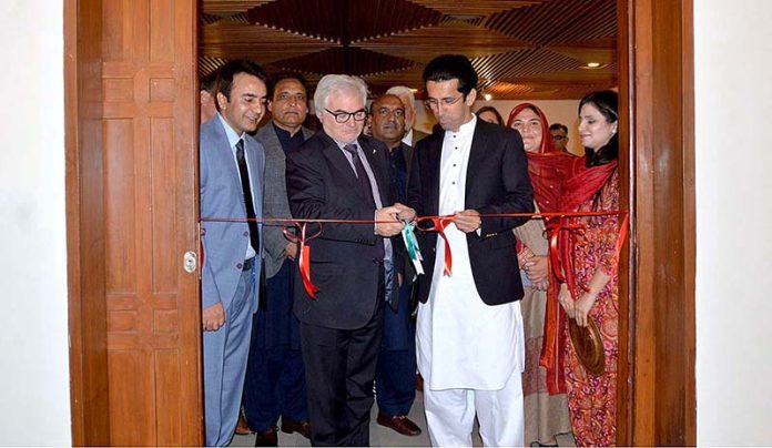 Shahram Khan Tarakai KP Minister for Elementary & Secondary Education and German Ambassador to Pakistan Alfred Grannas cutting ribbon to inaugurate the photographic exhibition on 
