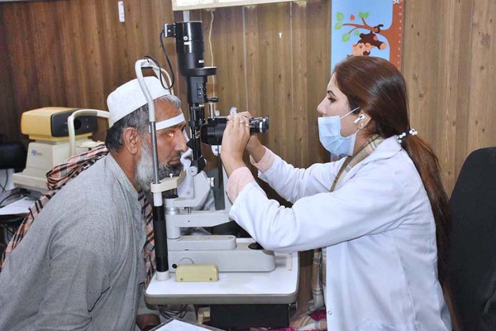 Eye Specialist check eye sight of a patients in free medical camp at Al-Sheikh Jinnah Memorial Welfare Teaching Hospital