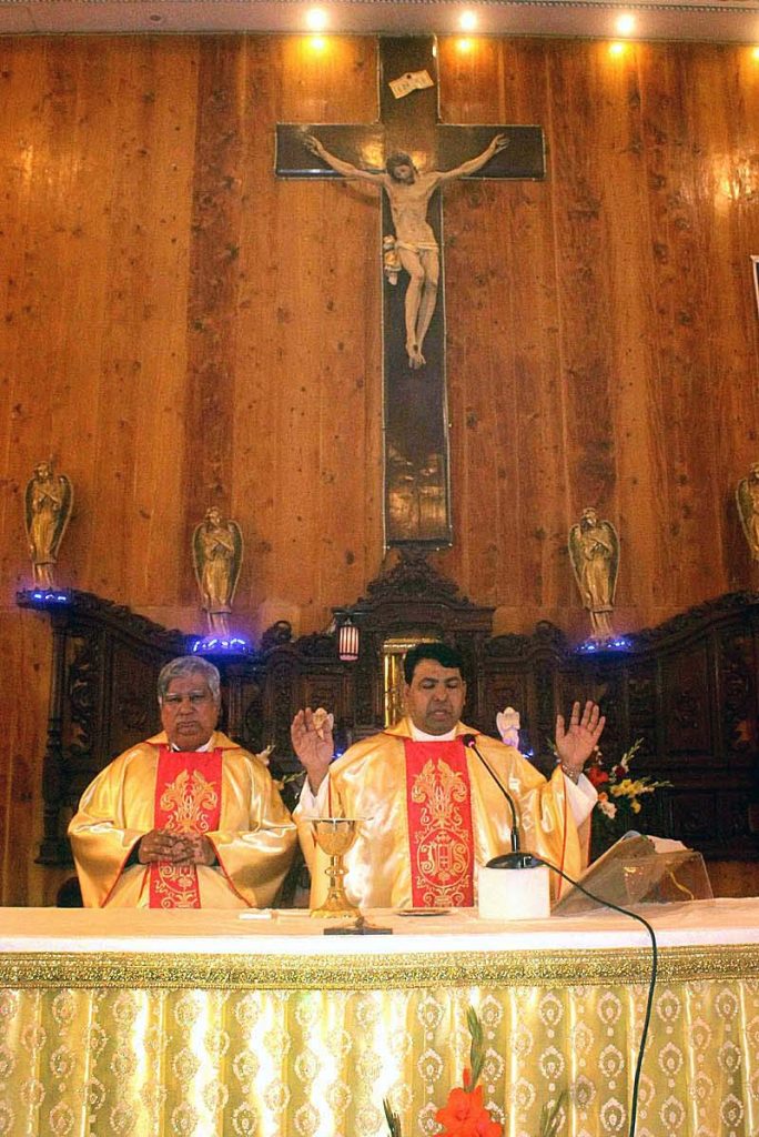 People from Christian community performing their religious rituals on a Christmas Day at Catholic Church.