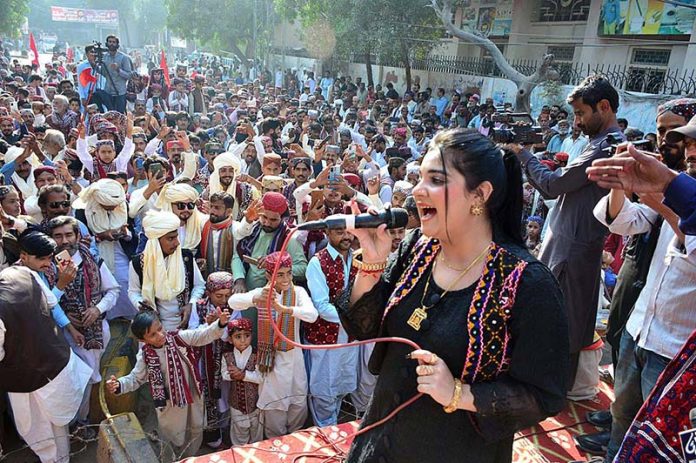 Female singer performing a sindhi song on the stage during culture program during the Sindhi Ajrak Topi culture day at radio Pakistan road.