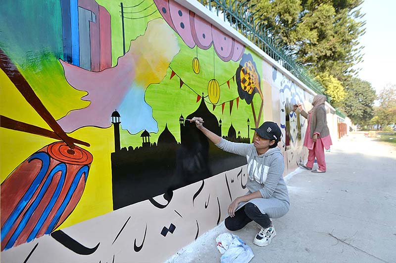 Artists giving final touch to the paintings on walls for maintaining beautification of the Federal Capital