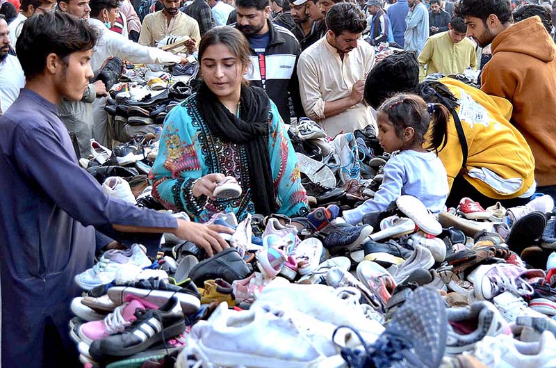 In the Landa Bazaar of the provincial capital, women are selecting and shopping second-hand children's shoes in preparation of the cold weather.