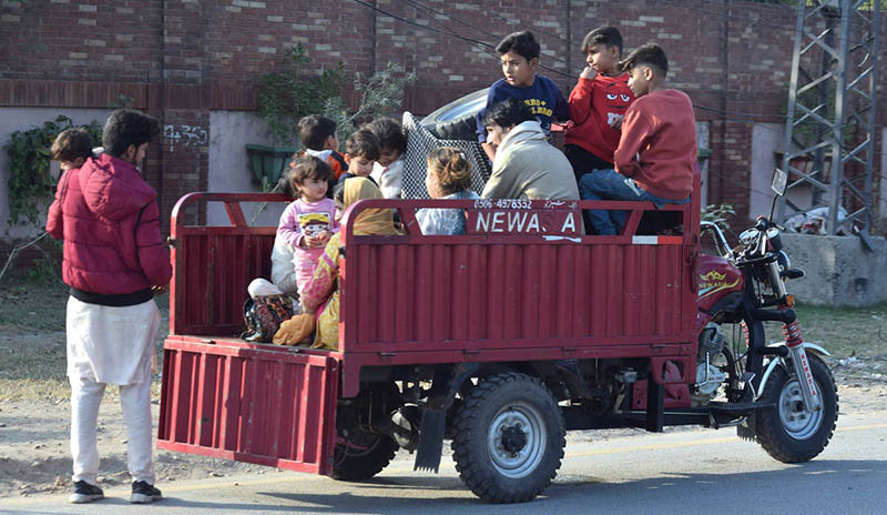 Gypsy family traveling on the loader rickshaw heading towards their destination