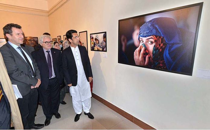 Shahram Khan Tarakai KP Minister for Elementary & Secondary Education and German Ambassador to Pakistan Alfred Grannas viewing the photographic exhibition on 
