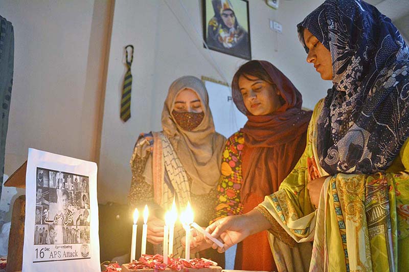 students are lighting candles to tribute martyrs of APS Peshawar at Khubaib Girls School and College